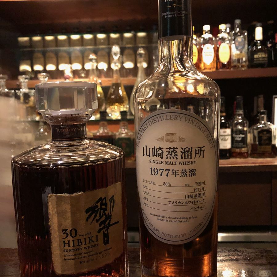 Rare Japanese whisky bottles lined up at a Ginza bar
